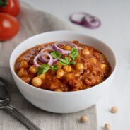 chole-masala-vegan-indian-food-made-chickpeas-tomatoes-bowl-with-spoon-textile