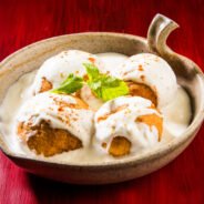 Dahi Vada or Bhalla is a popular snack in India served in a bowl. selective focus