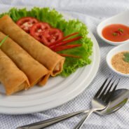 Egg roll or Fried Spring Rolls on the white plate Thai food. Selective focus.