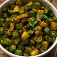 Indian style Masala Sabji OR Sabzi of fried Bhindi OR Okra also known as Ladyfinger, Served in a bowl over moody background. selective focus